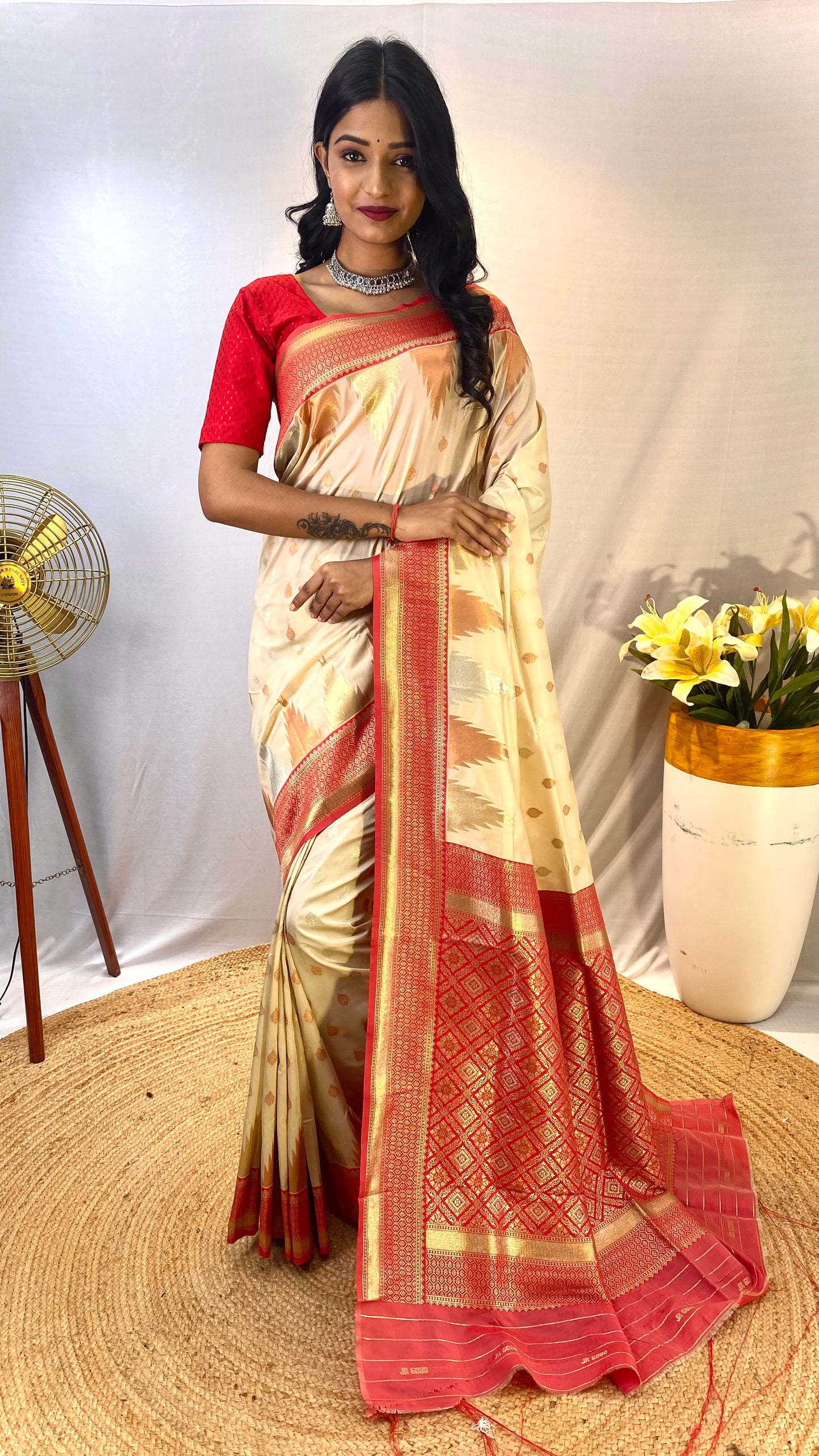 Cream 1 Kanchipuram sarees with a temple weaving border.