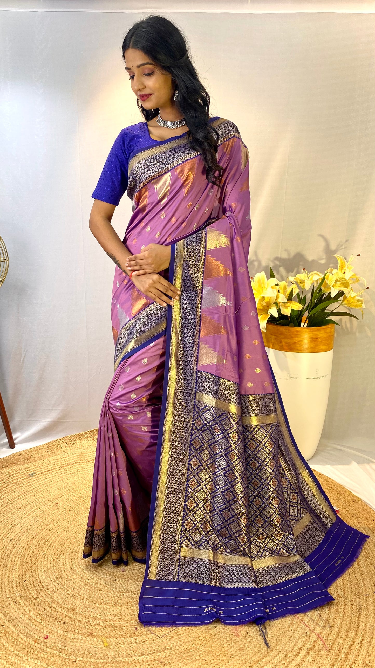 Lavendor Kanchipuram sarees with a temple weaving border.